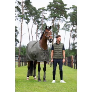 Eskadron Waterproof Lightweight Turnout in dusty olive green on a bay horse while a man stands next to it holding the leadrope and posing