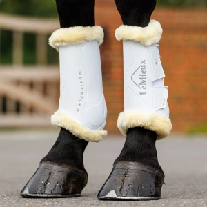 LeMieux Motionflex Dressage Boots with Fleece White worn by a dark bay horse