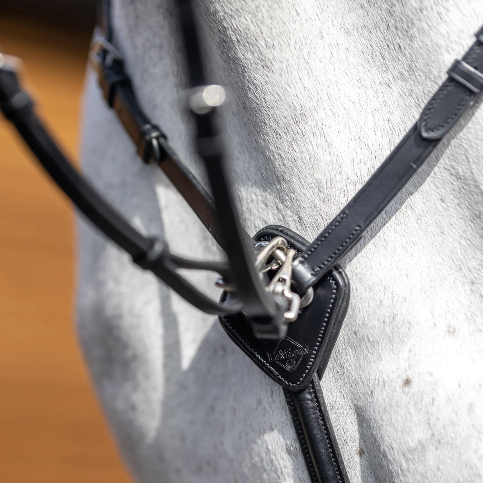 The LeMieux Kudos Breastplate (BLACK/SILVER) is an exceptional choice for equestrians seeking both style and functionality in their tack. Designed to complement your existing gear, this breastplate boasts a sleek, smart appearance while offering unparalleled practicality. Featuring an adjustable top piece, it sits comfortably with a soft leather pad at the wither, providing a secure and cushioned fit. The attachment to the elasticated neck straps ensures both flexibility and stability, allowing for greater comfort and movement for your horse. Furthermore, the thoughtful design incorporates padded cushioning behind the connector on the chest, which enhances comfort during use. This padding is especially beneficial for reducing any discomfort or pressure points, making the breastplate ideal for extended rides or intense training sessions. The removable running martingale attachment is also a standout feature, offering added versatility. The attachment is equipped with carabiner clips and durable metal fixings, ensuring a strong and secure connection, while the easy-to-use buckle closures allow for quick adjustments.